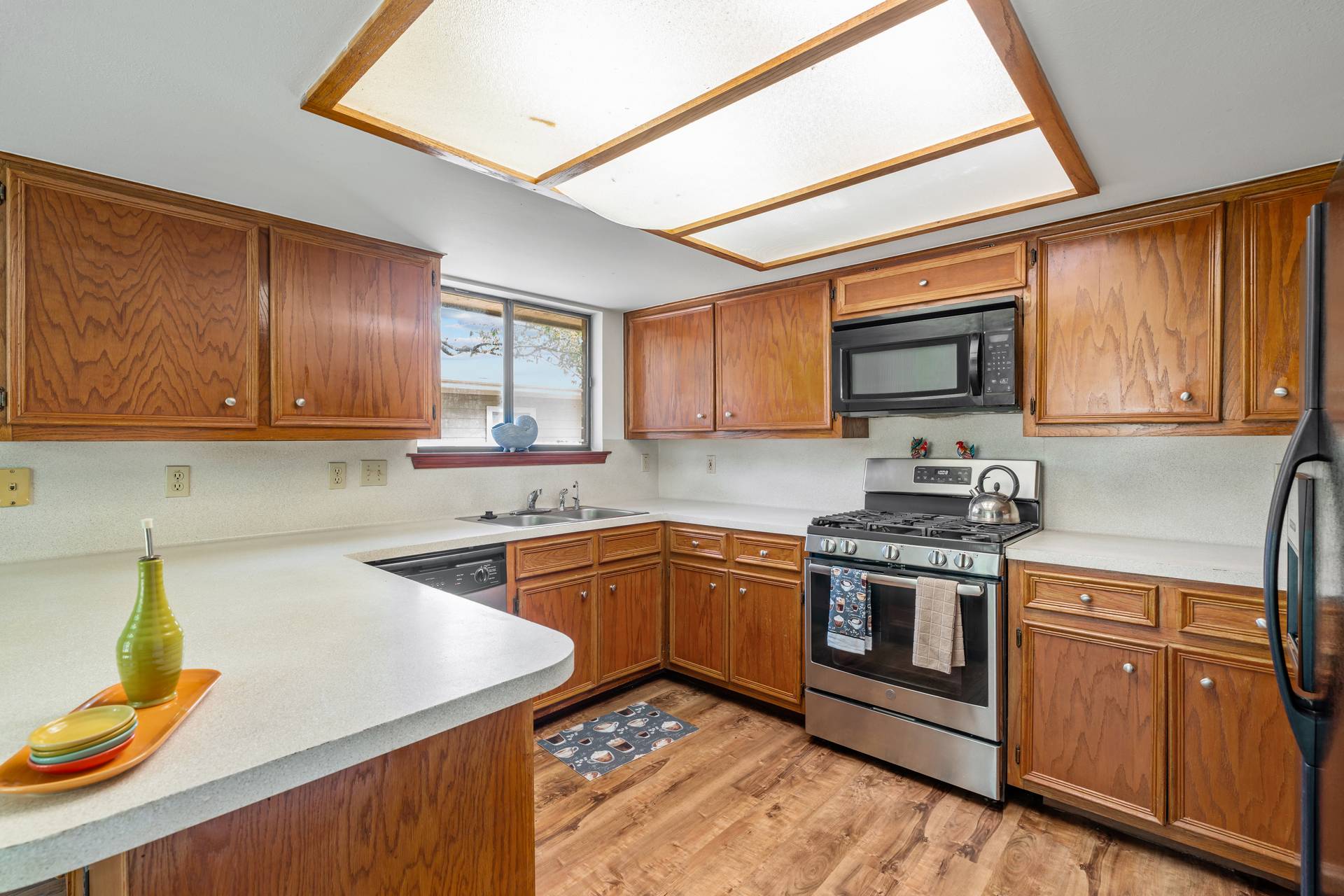 1802 Dixie Lane Round Rock, TX 78664 - Photo 10 of 30 a kitchen with stainless steel appliances granite countertop wooden cabinets a stove top oven a sink and dishwasher