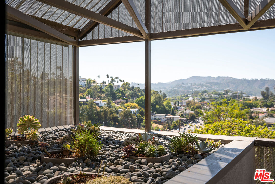 2634 Silver Ridge Avenue Los Angeles, CA 90039 - Photo 23 of 44 a view of a porch with a table chairs and a potted plant