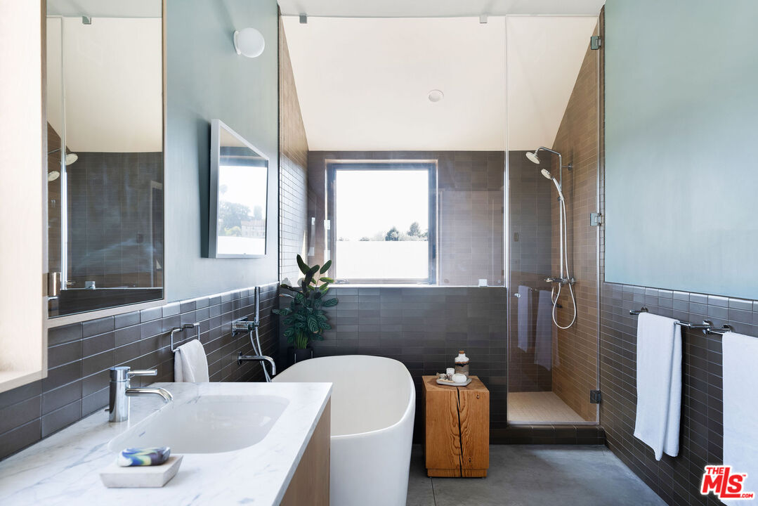 2634 Silver Ridge Avenue Los Angeles, CA 90039 - Photo 29 of 44 a bathroom with a sink and a large mirror