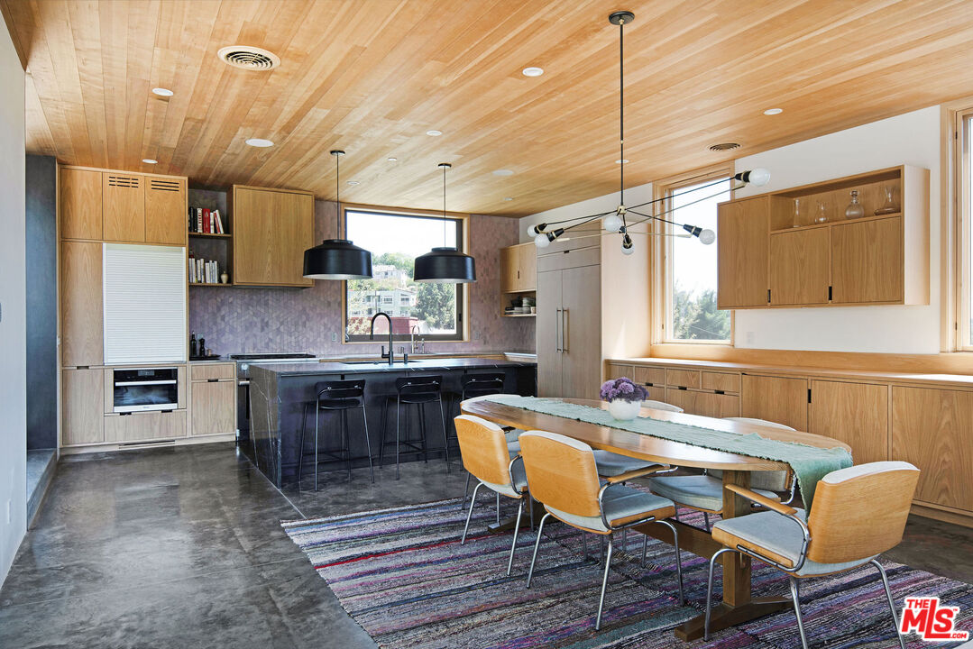 2634 Silver Ridge Avenue Los Angeles, CA 90039 - Photo 8 of 44 a kitchen with a dining table chairs cabinets and stainless steel appliances
