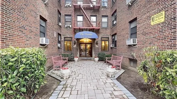 a front view of a building with sitting area