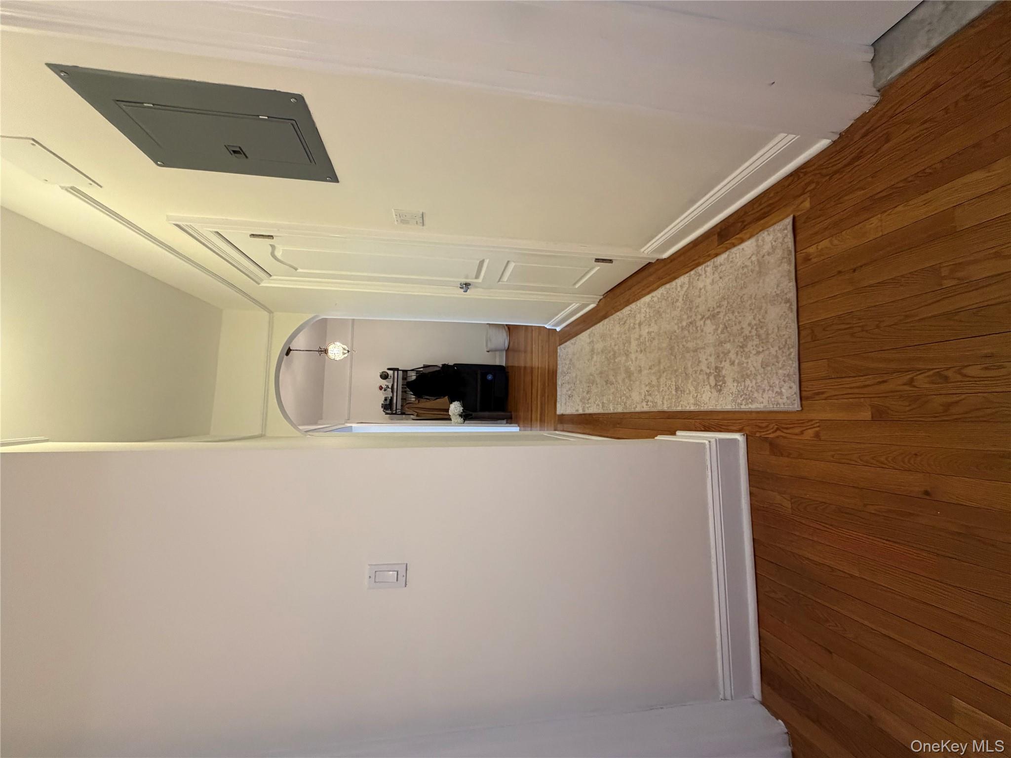 8384 116th Street, Unit 5G Queens, NY 11418 - Photo 6 of 17 a view of a hallway with wooden floor and a bathroom