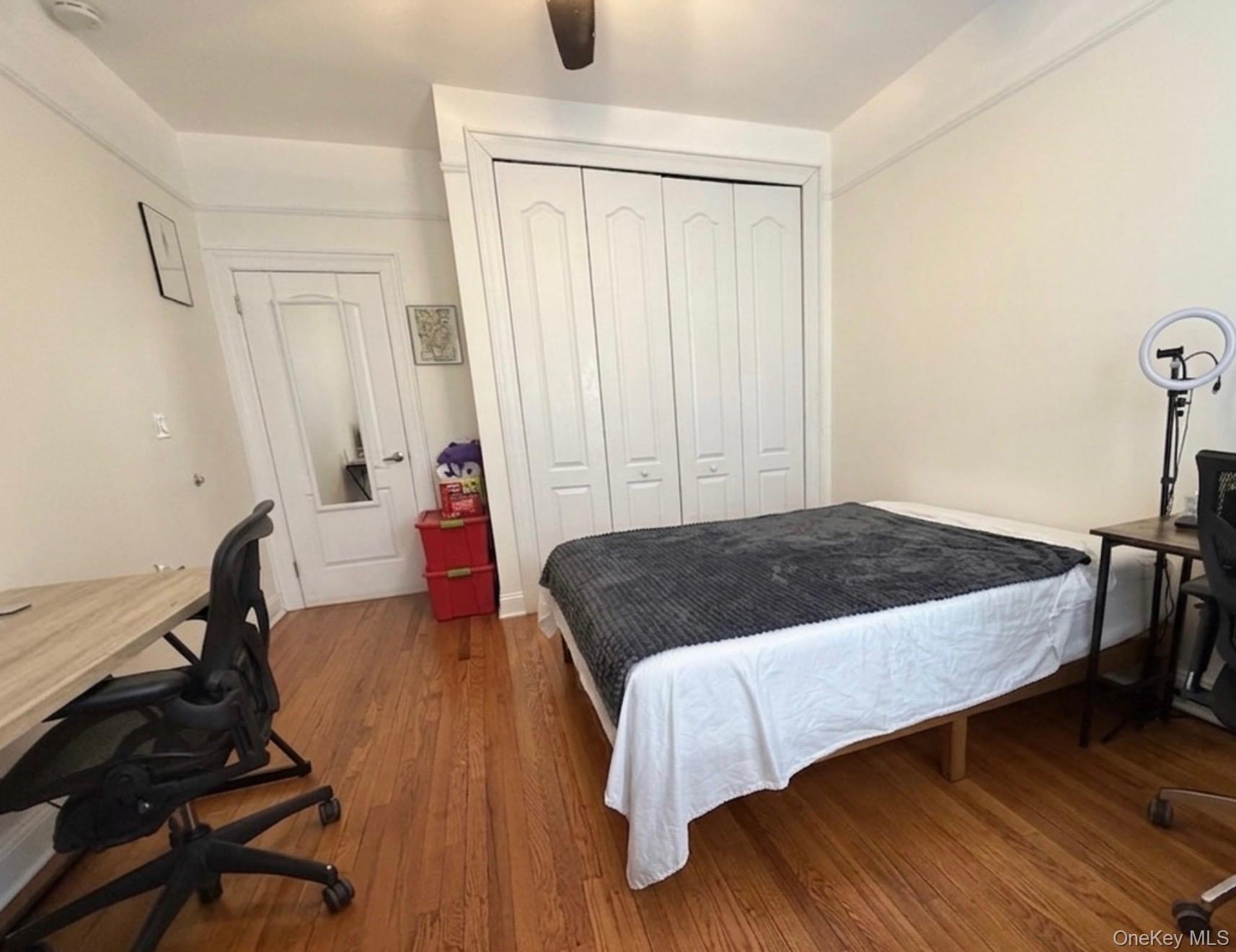 8384 116th Street, Unit 5G Queens, NY 11418 - Photo 8 of 17 a bedroom with a bed and wooden floor