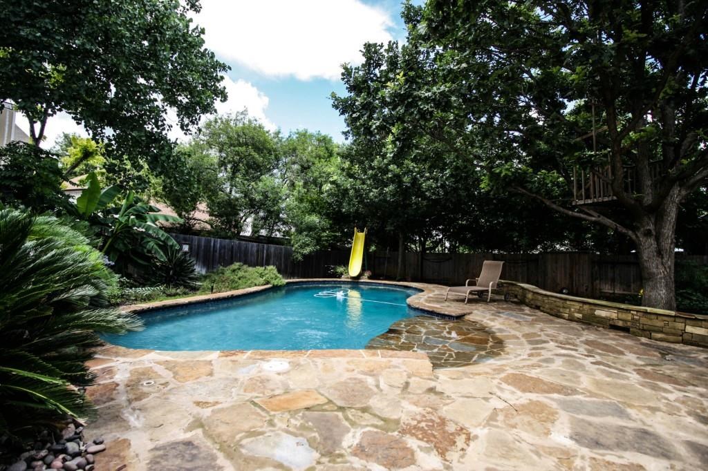 a view of swimming pool with a patio and yard