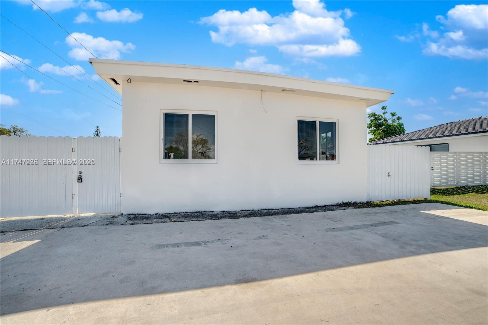 10272 Southwest 178th Street, Unit 1 Miami, FL 33157 - Photo 3 of 8 a view of a house with a backyard