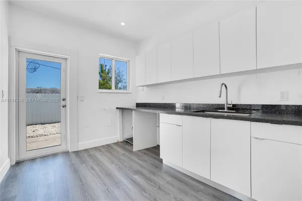 a kitchen with a sink and cabinets