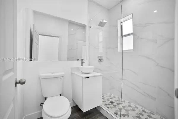 a bathroom with a sink toilet and shower