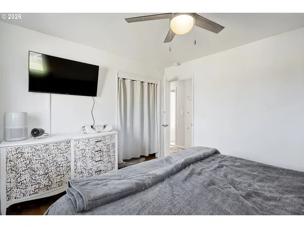 a living room with a flat screen tv and a chandelier