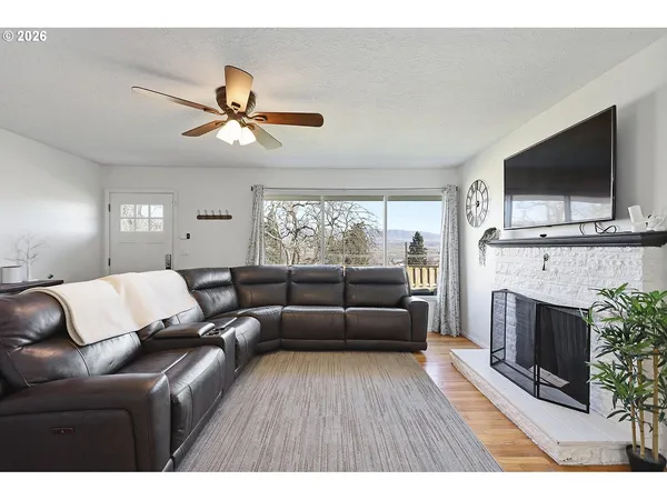 a living room with furniture a flat screen tv and a fireplace