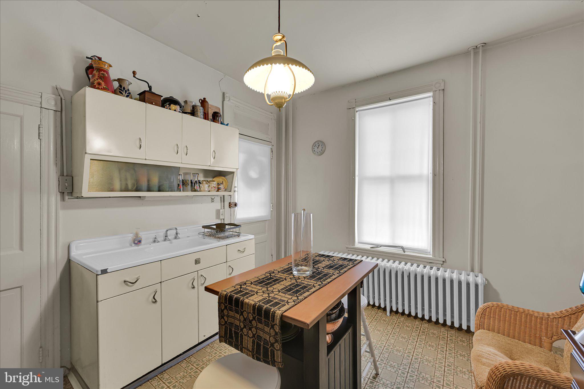 529 Windsor Street Reading, PA 19601 - Photo 13 of 36 a kitchen with a stove a sink and a window
