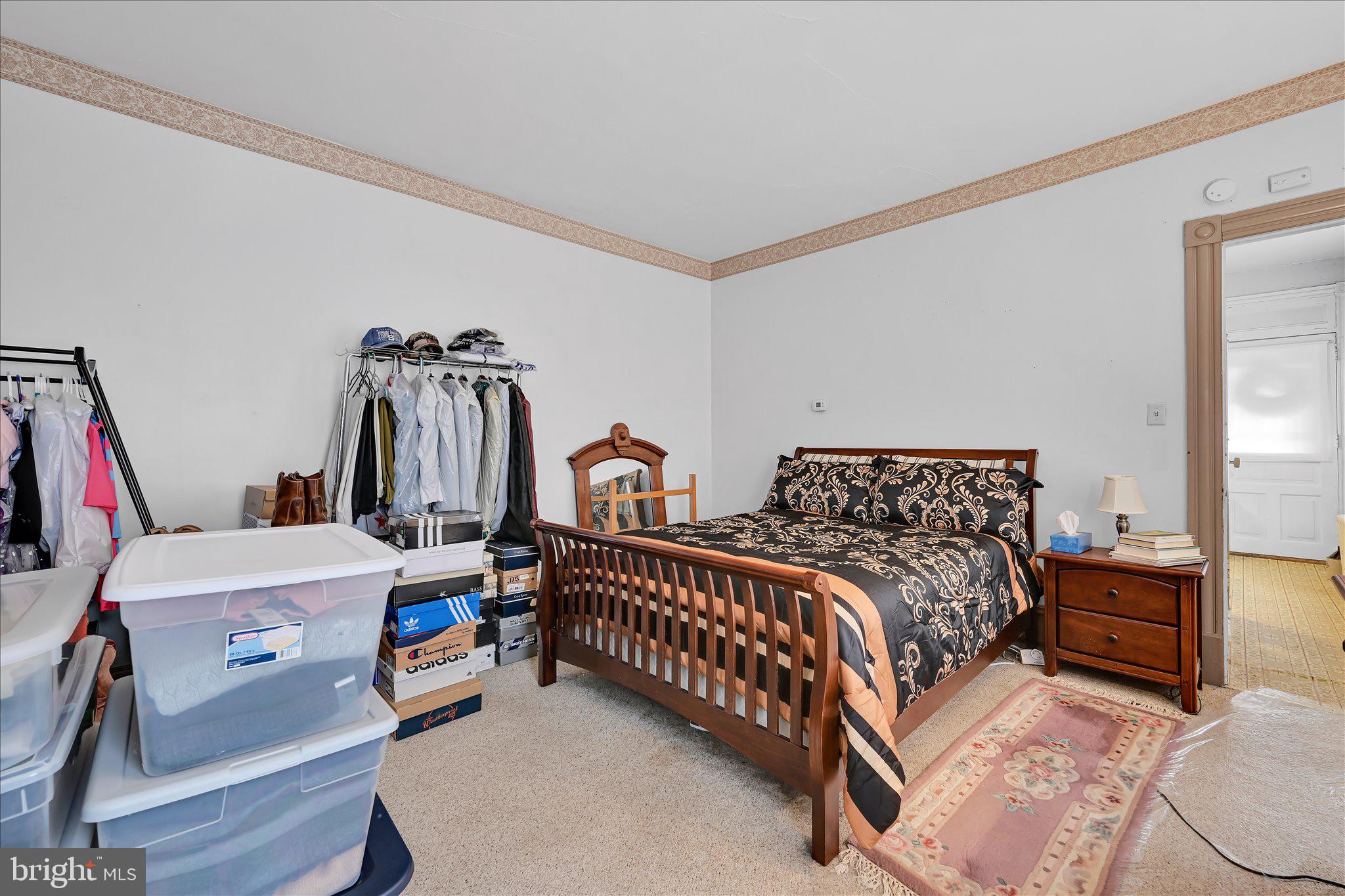 529 Windsor Street Reading, PA 19601 - Photo 16 of 36 a bedroom with bed and a chandelier