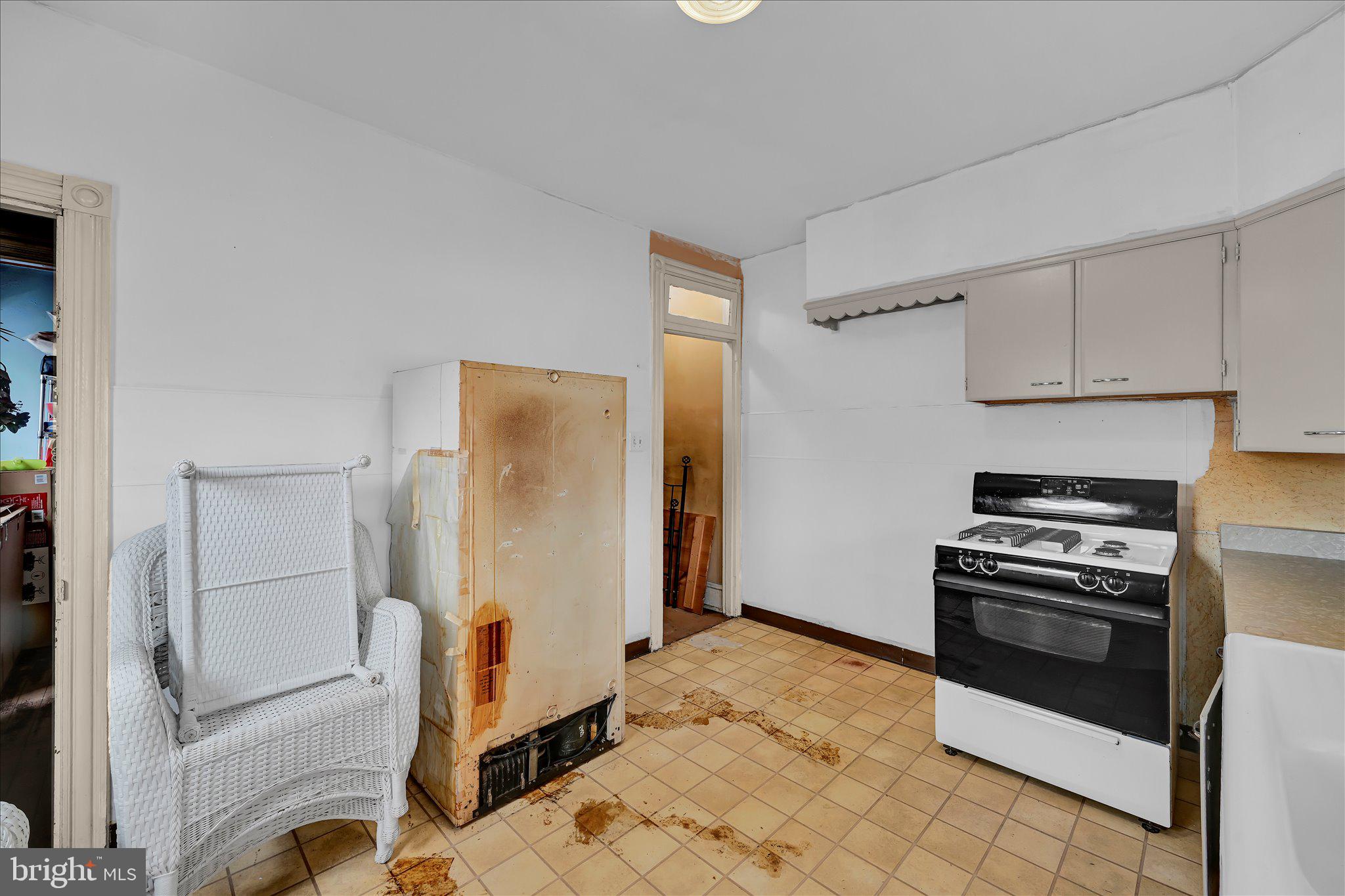 529 Windsor Street Reading, PA 19601 - Photo 24 of 36 a kitchen with a refrigerator and a stove top oven