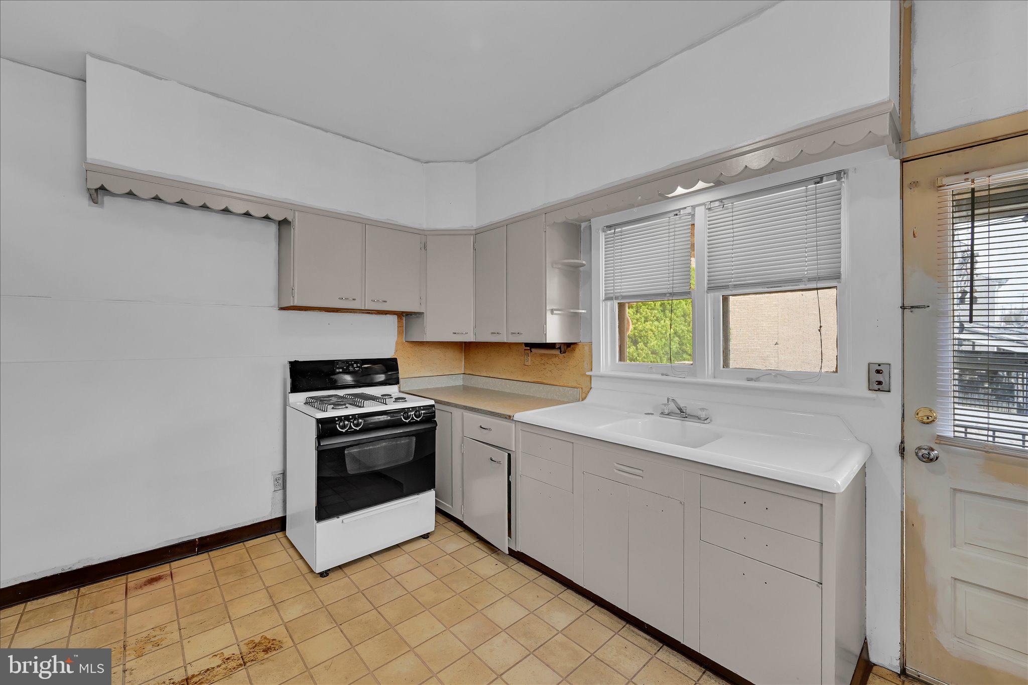 529 Windsor Street Reading, PA 19601 - Photo 25 of 36 a kitchen with a sink stove and cabinets