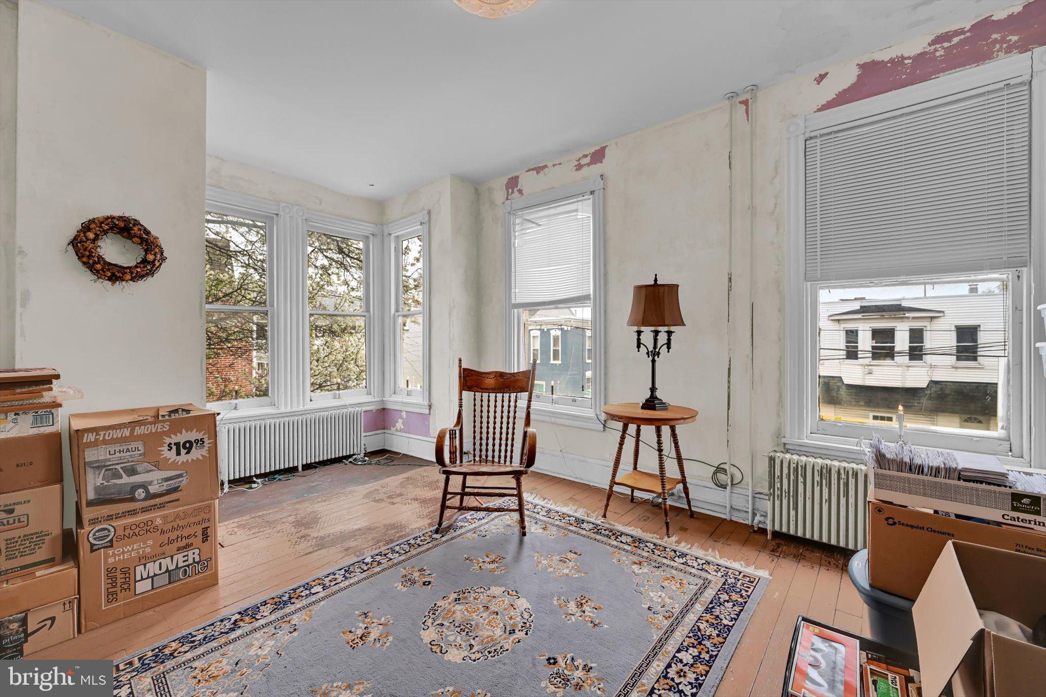 529 Windsor Street Reading, PA 19601 - Photo 26 of 36 a living room with furniture a flat screen tv and a window