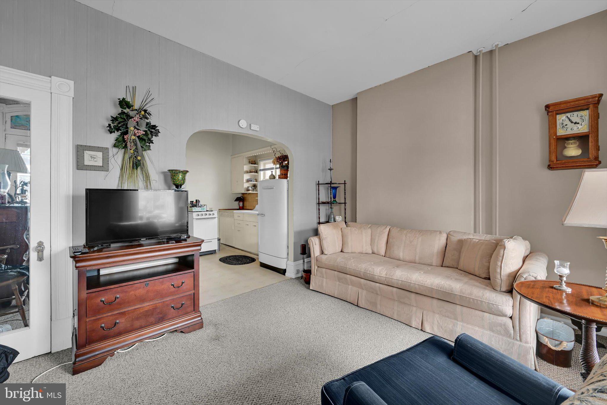 529 Windsor Street Reading, PA 19601 - Photo 6 of 36 a living room with furniture and a flat screen tv
