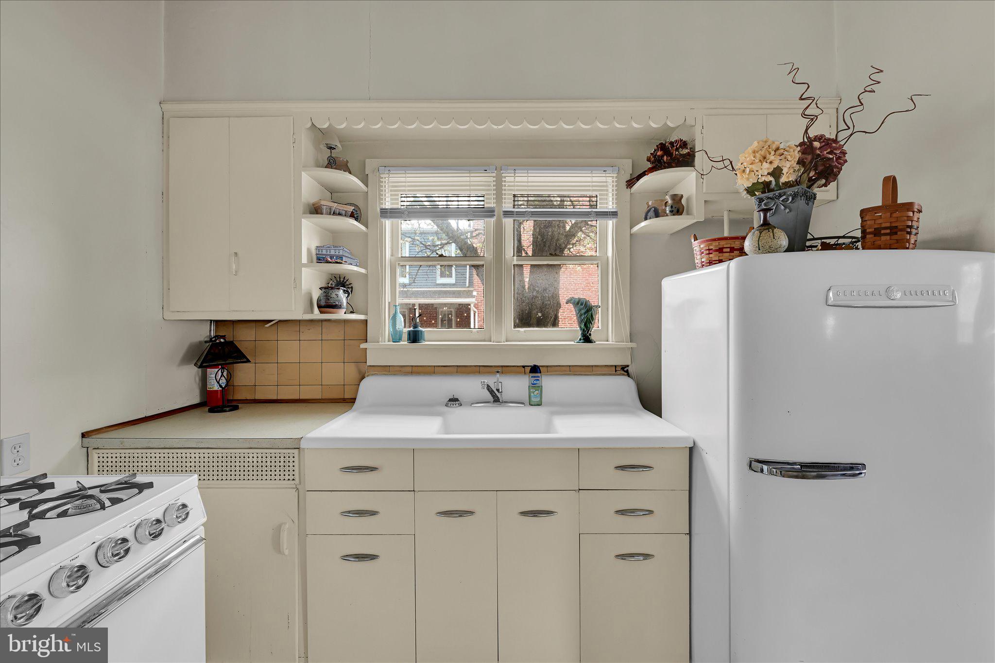 529 Windsor Street Reading, PA 19601 - Photo 10 of 36 a kitchen with stainless steel appliances granite countertop a sink a stove and a refrigerator