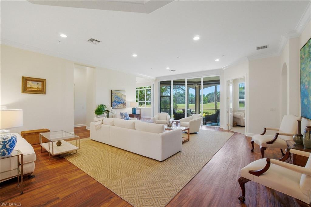 17015 Porta Vecchio Way, Unit 101 Naples, FL 34110 - Photo 7 of 39 a living room with furniture and a large window