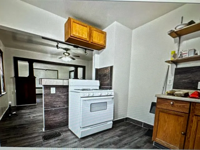 a view of kitchen with cabinets and wooden floor