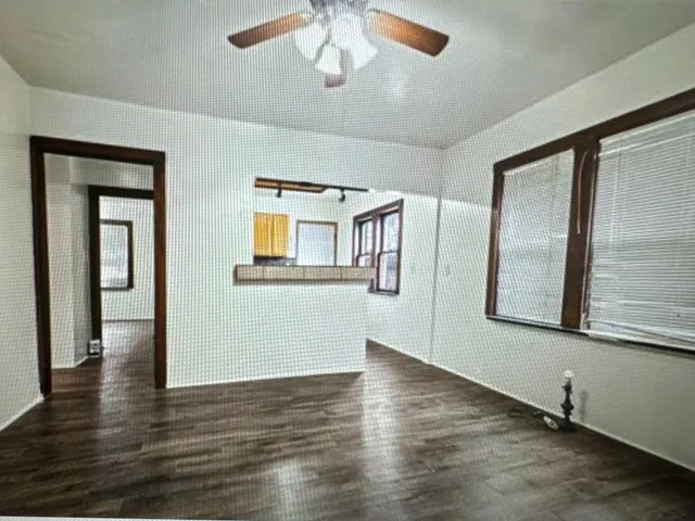 a view of a room with wooden floor and cabinet