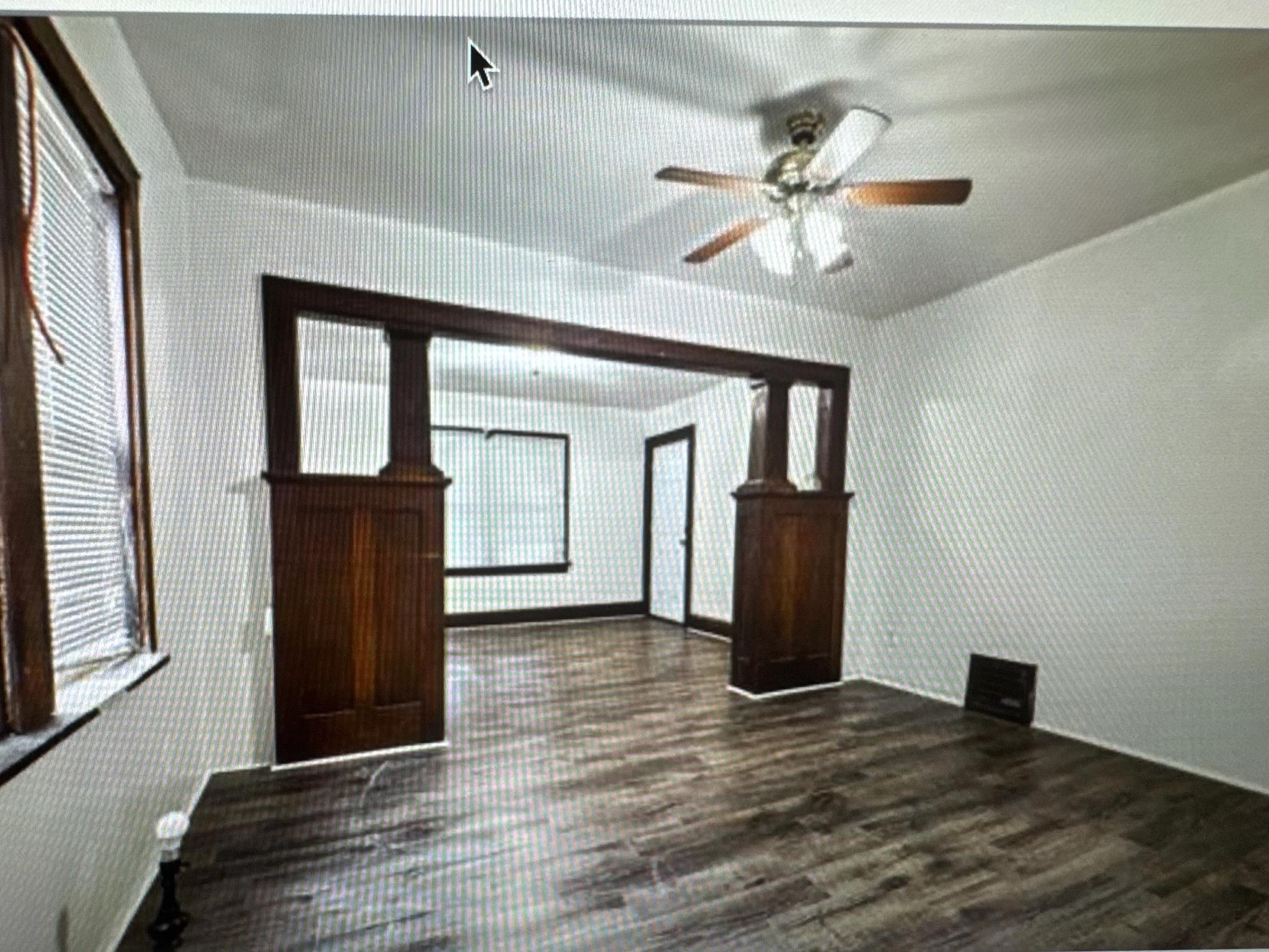 314 North Longwood Street Rockford, IL 61107 - Photo 5 of 11 a view of a hallway with wooden floor and a ceiling fan