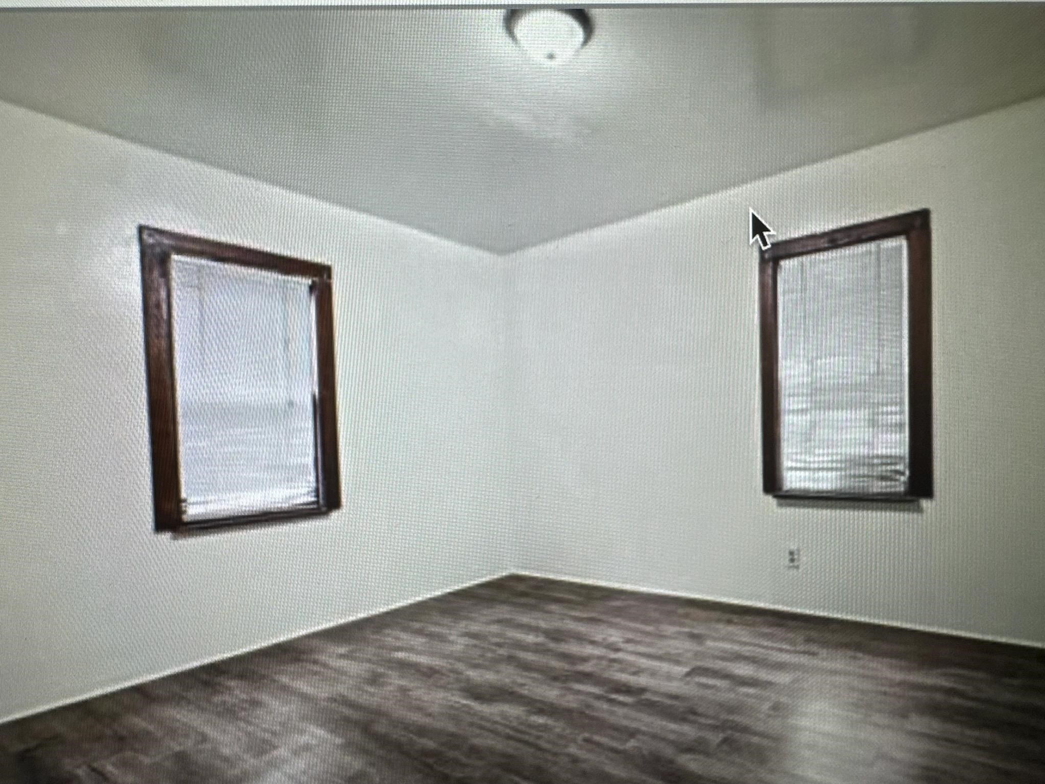 314 North Longwood Street Rockford, IL 61107 - Photo 6 of 11 an empty room with wooden floor and windows