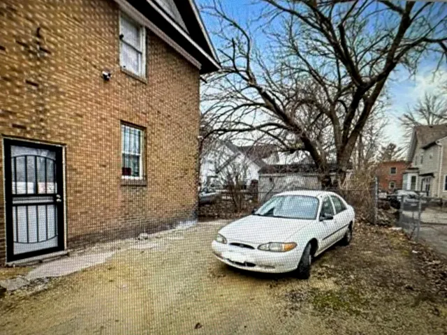 a view of a backyard with table and chairs and floor to ceiling window