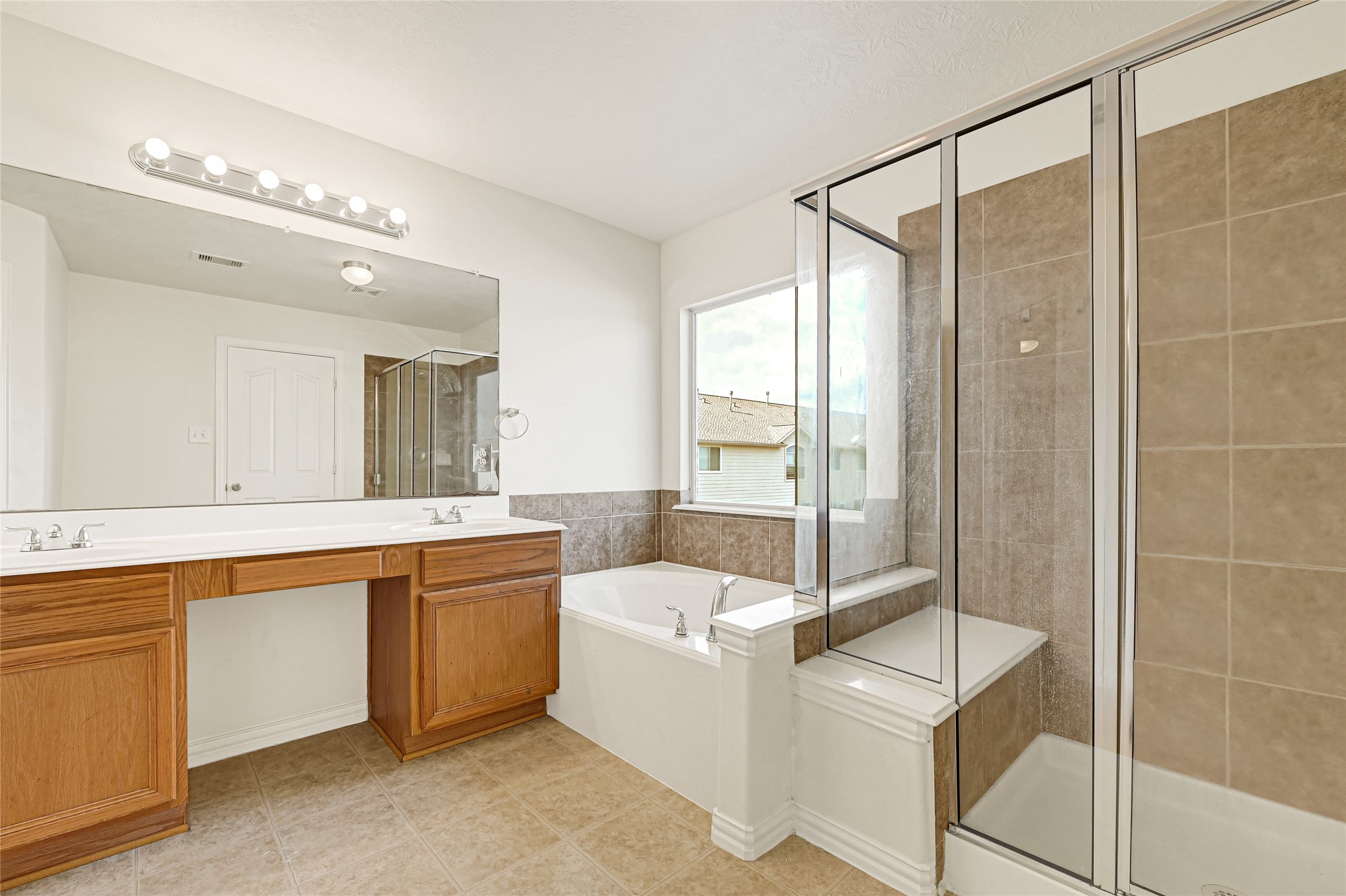 5010 Dartmoor Ridge Trail Houston, TX 77066 - Photo 16 of 28 a bathroom with a tub sink and mirror