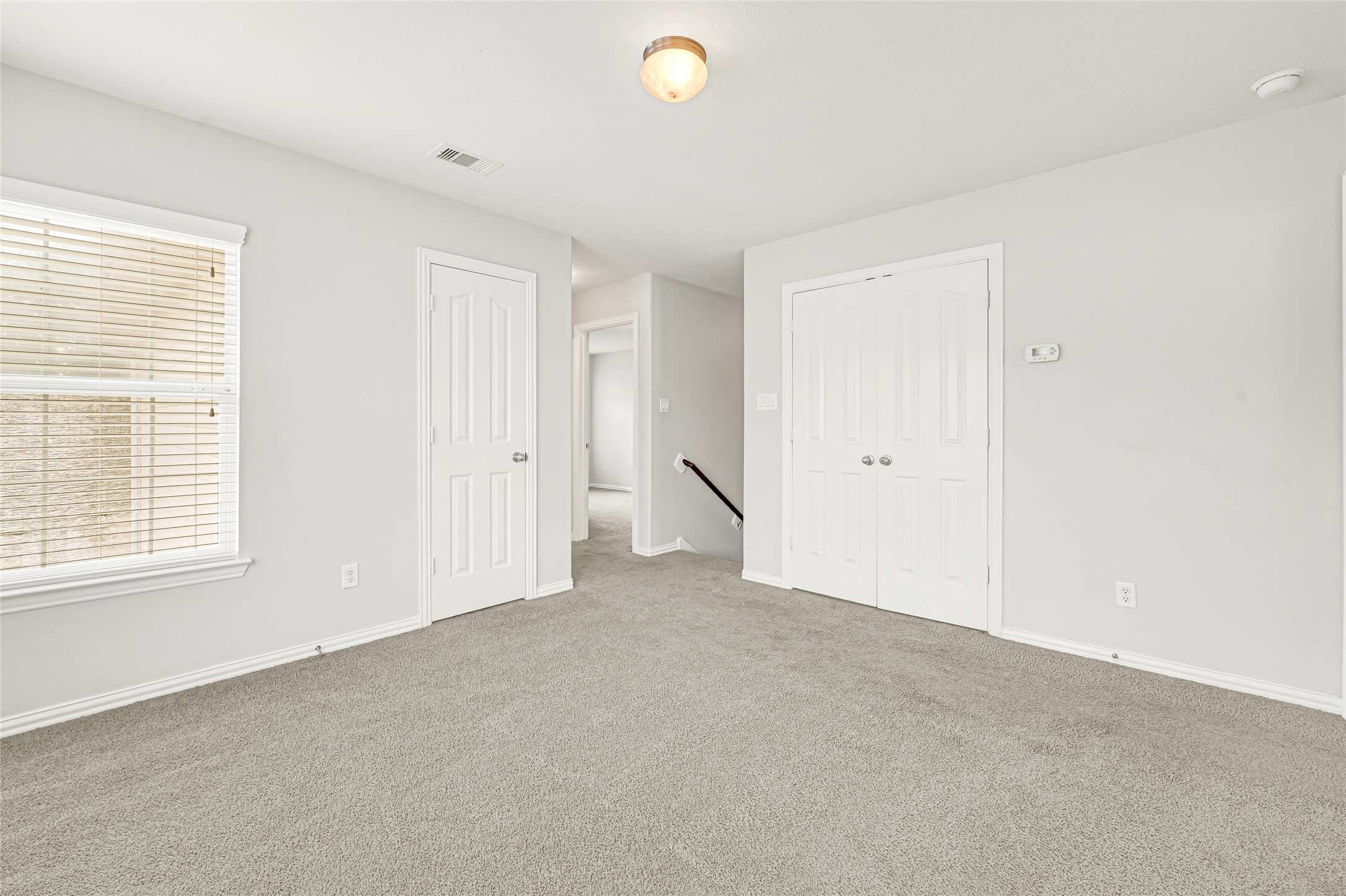 5010 Dartmoor Ridge Trail Houston, TX 77066 - Photo 26 of 28 an empty room with windows and closet