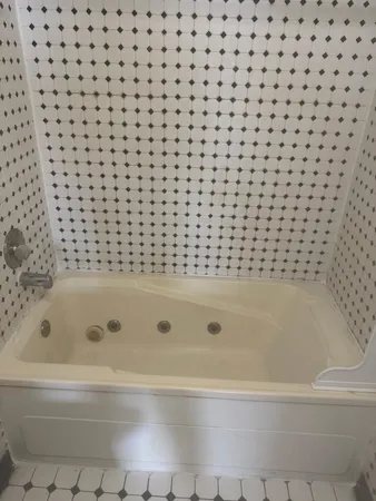 a bathroom with a bathtub and shower