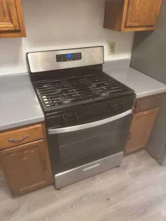 a stove top oven sitting inside of a kitchen