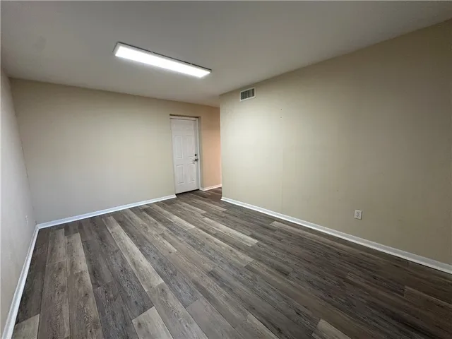 a bathroom with a granite countertop sink toilet a mirror and vanity