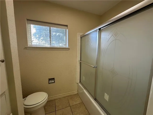 a view of empty room with wooden floor and window