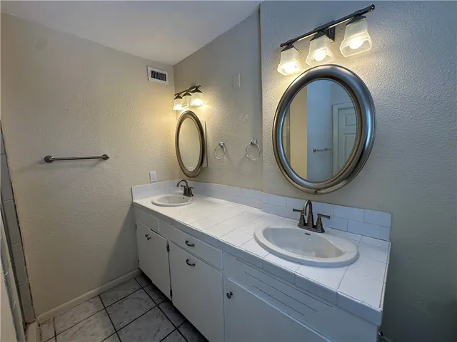 a view of a backyard with wooden fence and a backyard