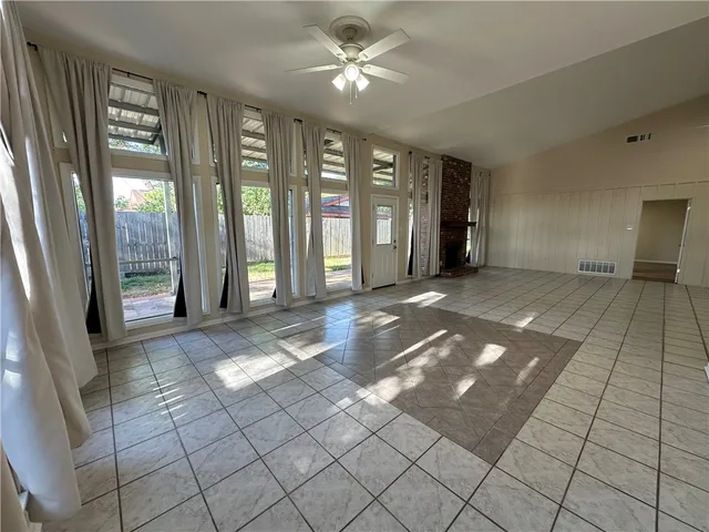 a view of an empty room with glass door