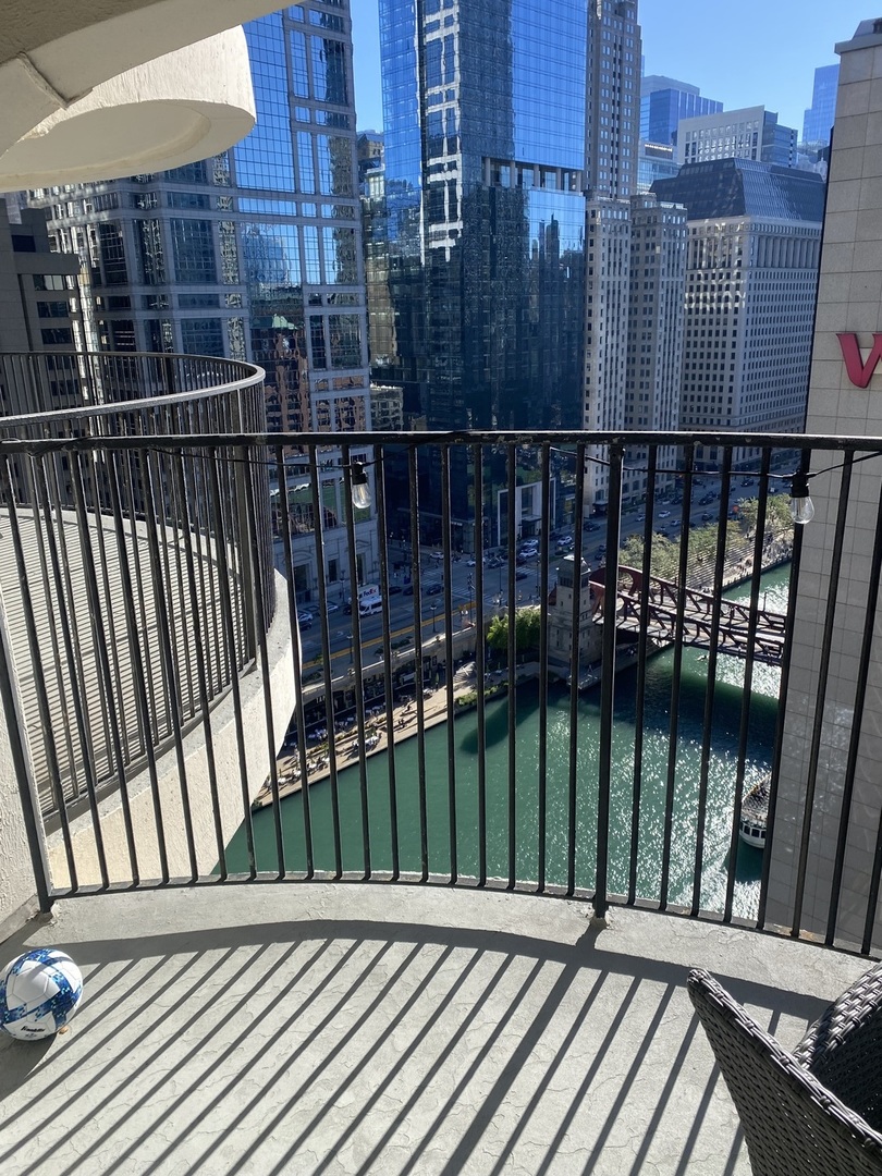 300 North State Street, Unit 2103 Chicago, IL 60654 - Photo 3 of 26 a view of a balcony with wooden floor