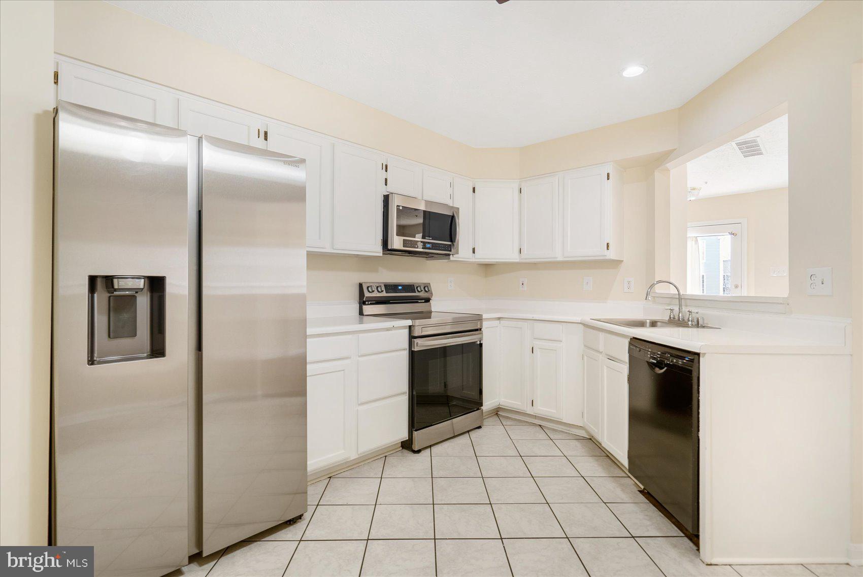 4260 Maple Path Circle, Unit 15 Nottingham, MD 21236 - Photo 12 of 35 a kitchen with stainless steel appliances granite countertop a refrigerator and a stove top oven