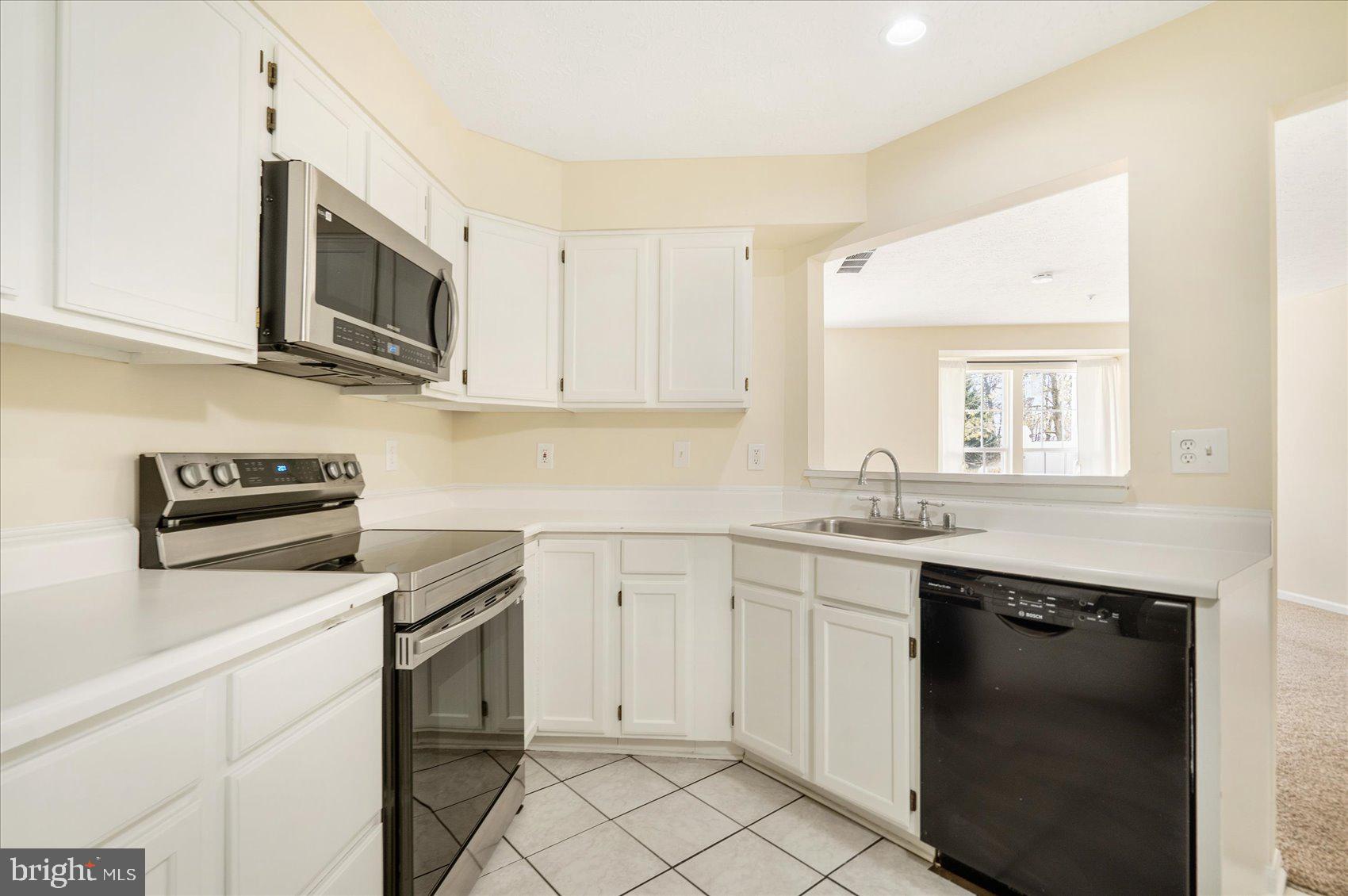 4260 Maple Path Circle, Unit 15 Nottingham, MD 21236 - Photo 13 of 35 a kitchen with cabinets appliances and a window