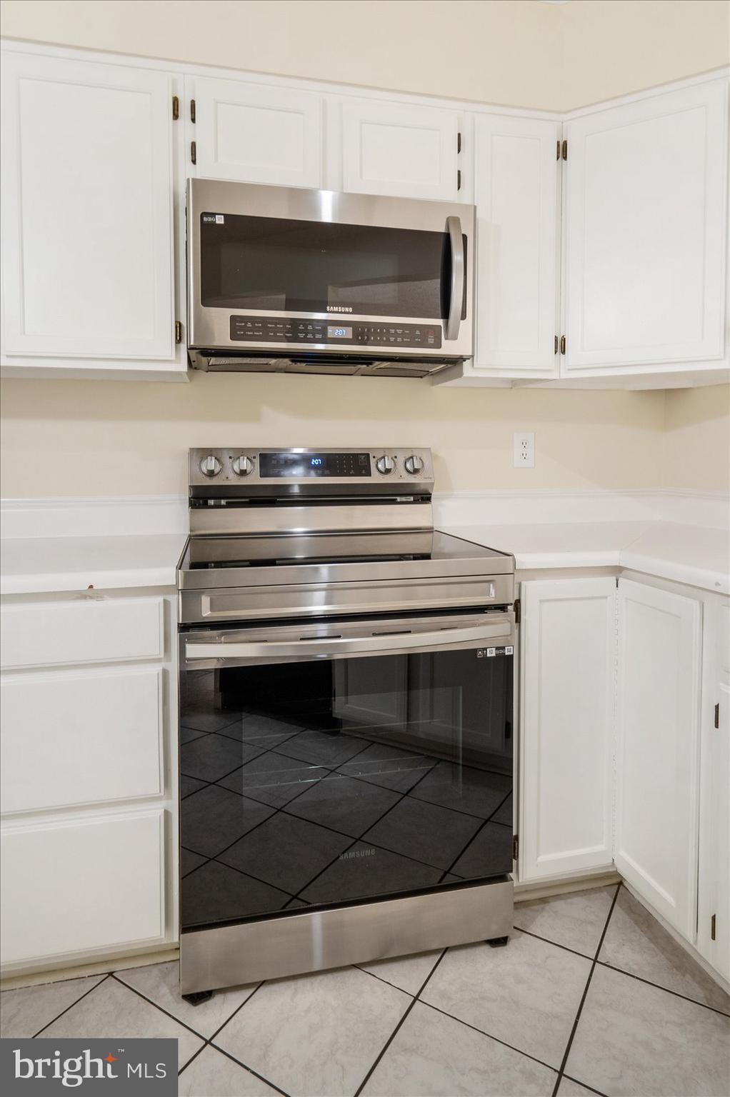 4260 Maple Path Circle, Unit 15 Nottingham, MD 21236 - Photo 14 of 35 a kitchen with stainless steel appliances granite countertop a stove microwave and oven