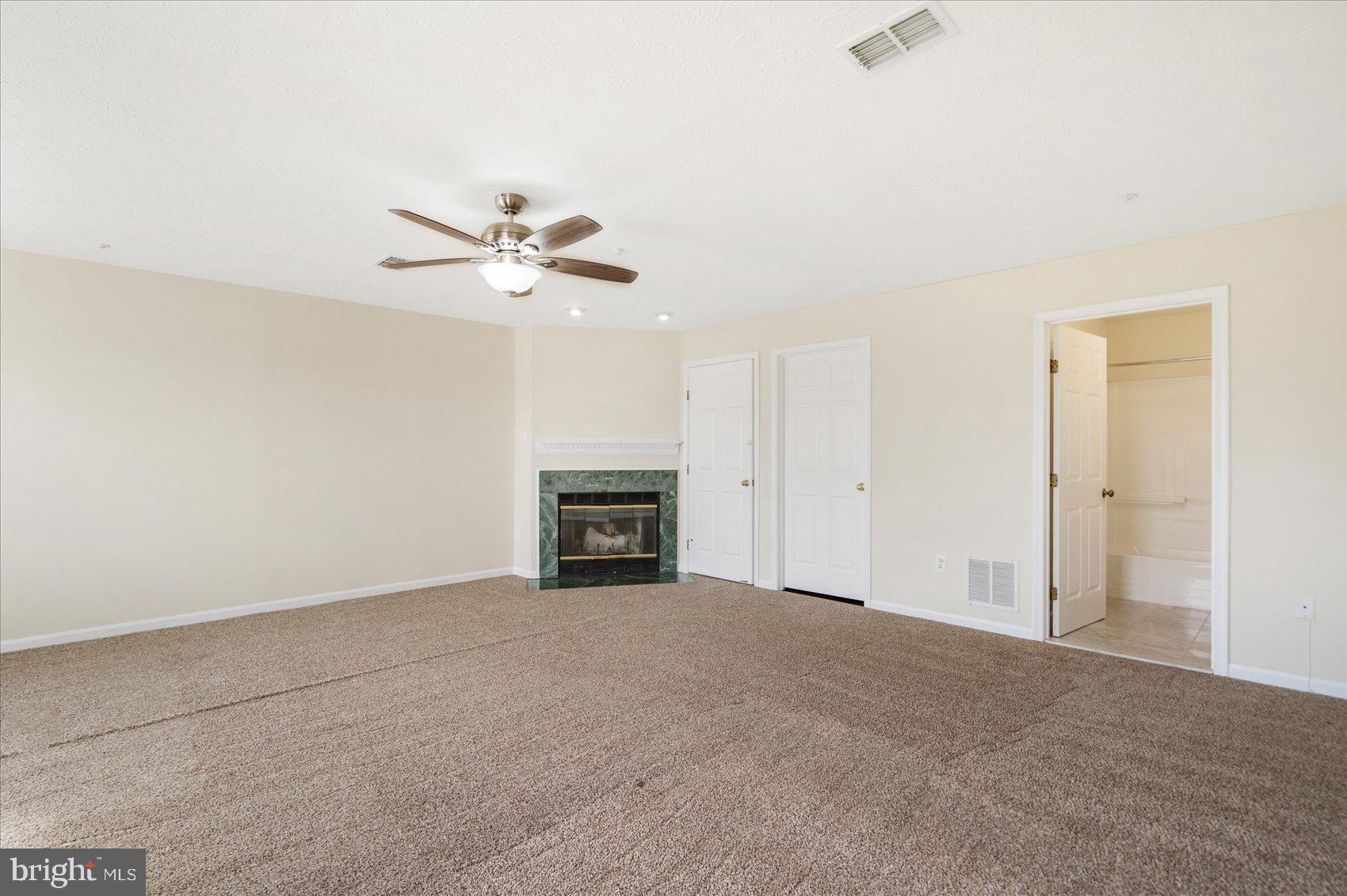 4260 Maple Path Circle, Unit 15 Nottingham, MD 21236 - Photo 28 of 35 an empty room with fireplace and fan