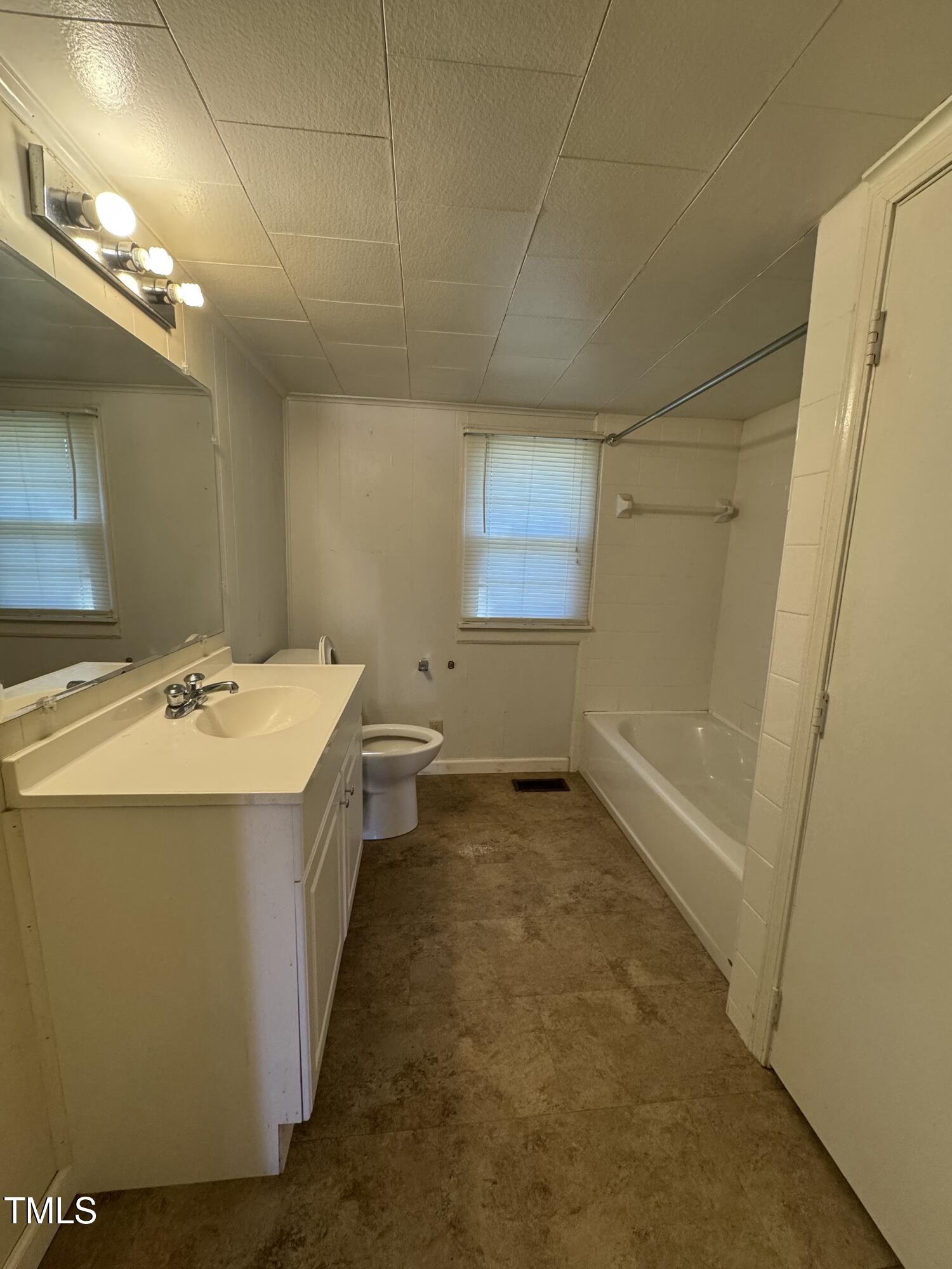 3001 Friendship Road Apex, NC 27502 - Photo 5 of 7 a bathroom with a sink a toilet and mirror