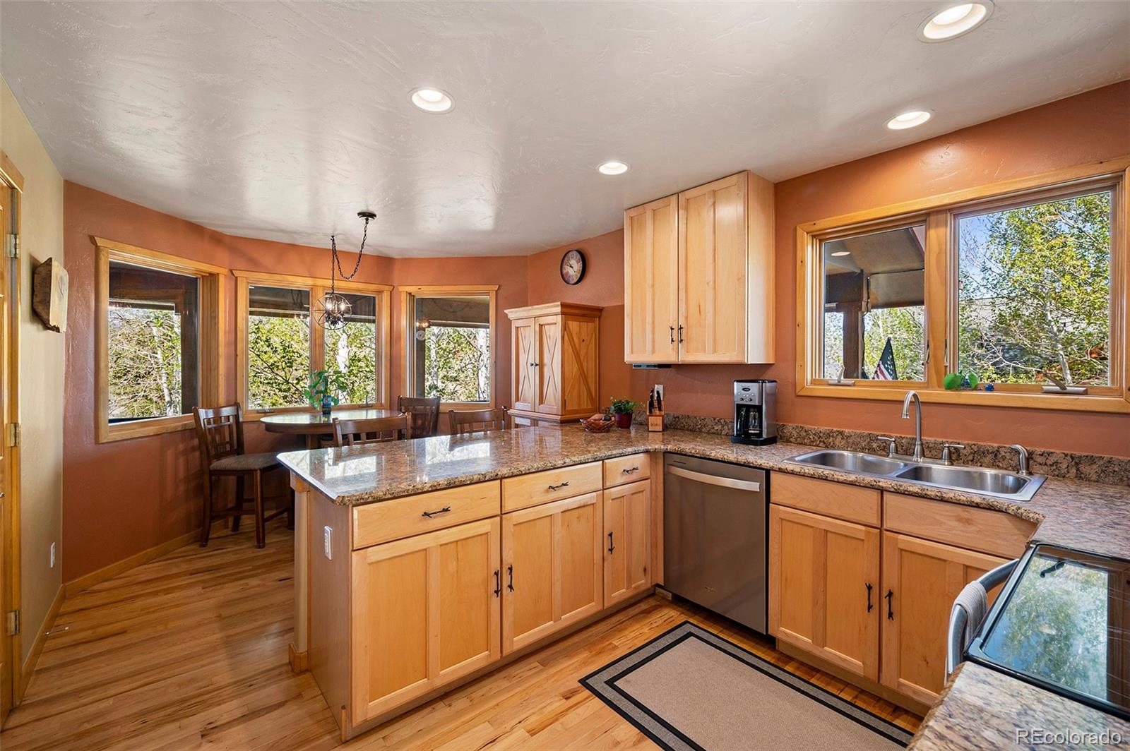 290 Village Road Granby, CO 80446 - Photo 10 of 45 a kitchen with a sink stove and cabinets