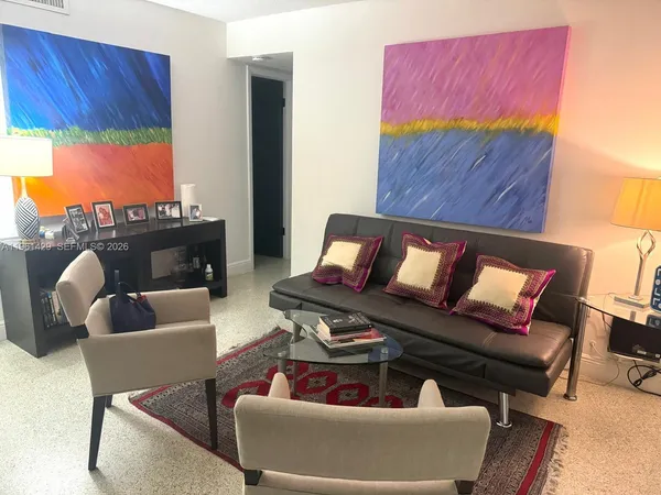 a living room with furniture a rug and a fireplace