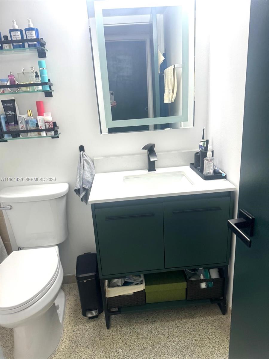 755 Southwest 6th Street, Unit 6 Miami, FL 33130 - Photo 17 of 20 a bathroom with a sink toilet and mirror