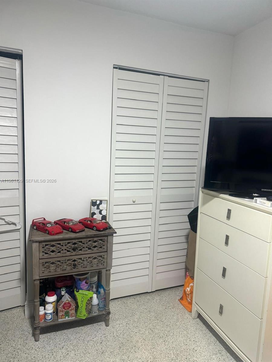 755 Southwest 6th Street, Unit 6 Miami, FL 33130 - Photo 19 of 20 a room with a flat screen tv dressers and chandelier