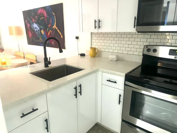 a kitchen with a sink and cabinets