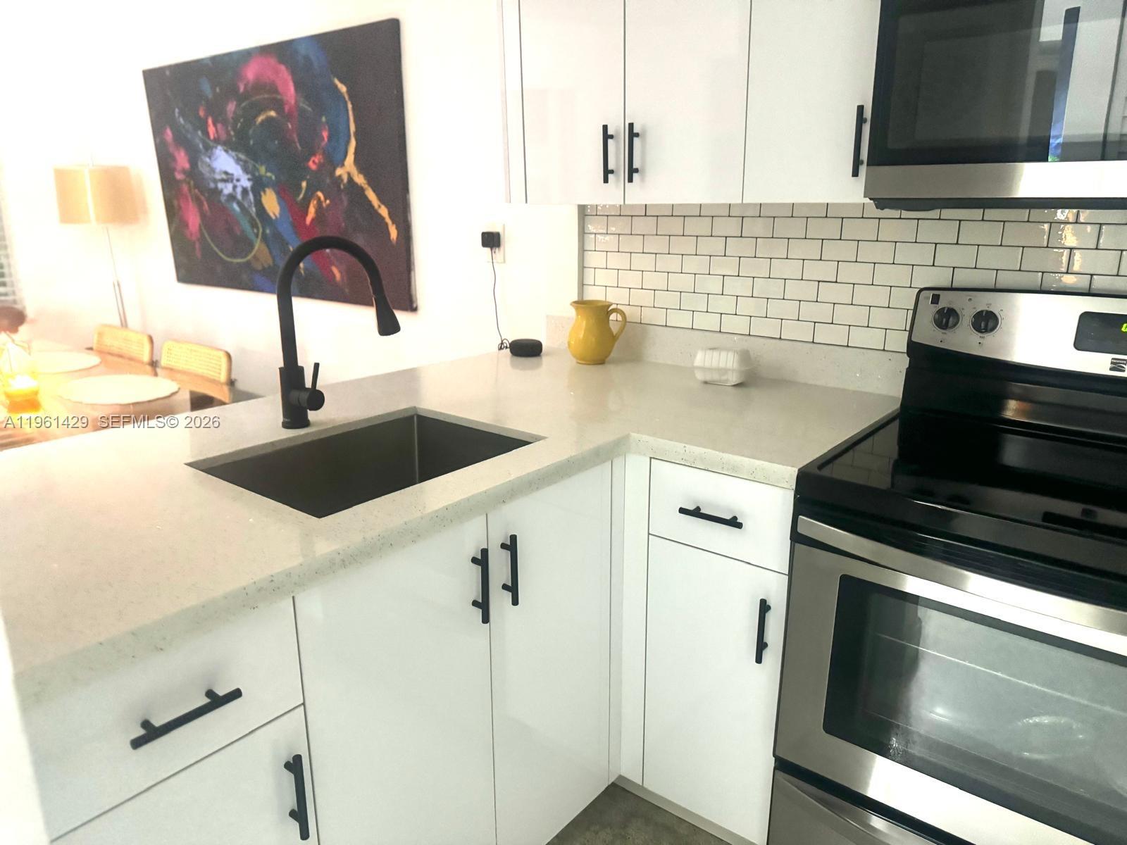 755 Southwest 6th Street, Unit 6 Miami, FL 33130 - Photo 7 of 20 a kitchen with a sink and cabinets
