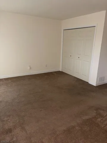 an empty room with staircase and white walls