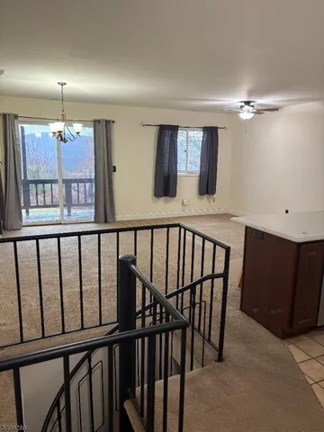 a view of a hallway with seating space