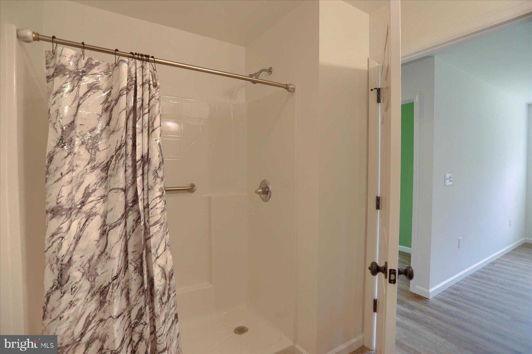 3497 New Lancaster Valley Road Milroy, PA 17063 - Photo 14 of 30 a bathroom with a shower and a glass door