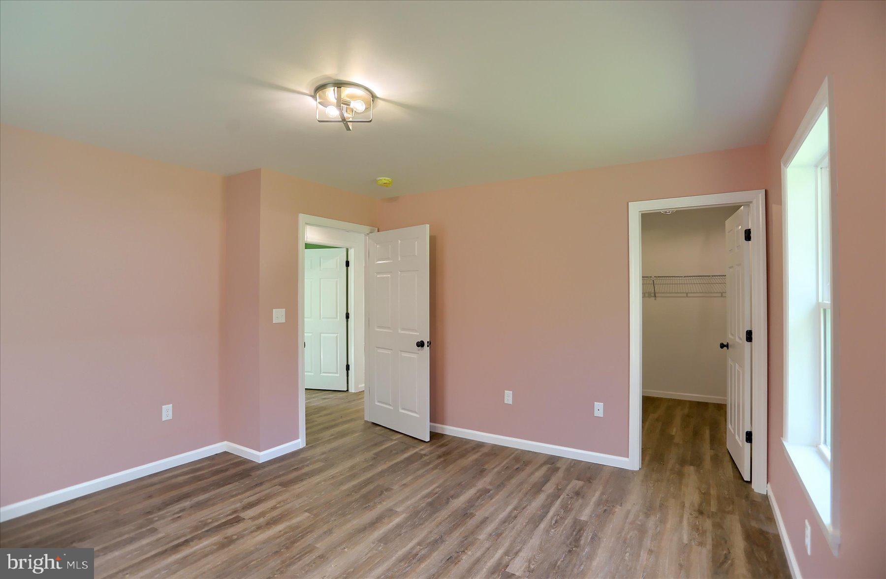 3497 New Lancaster Valley Road Milroy, PA 17063 - Photo 15 of 30 a view of a room with wooden floor and a ceiling fan